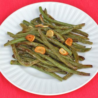 Roasted Garlicky Green Beans are a crisp and delicious side dish - you'll never look at green beans the same way again! Get the gluten-free, vegan, nut-free recipe @jlevinsonrd.