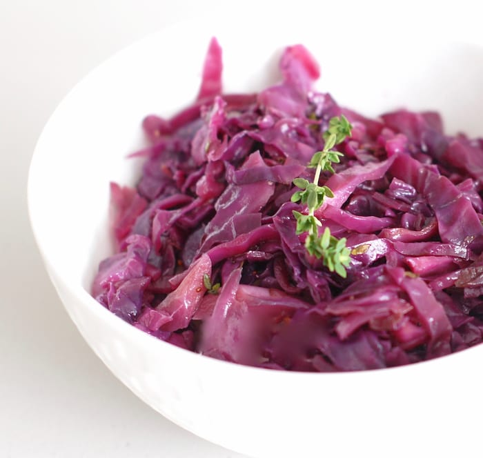 close up side view of braised red cabbage and apples