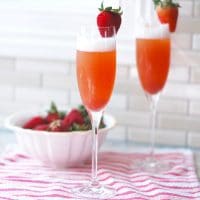 Brighten up your weekend with this pretty in pink Strawberry Rhubarb Mimosa, a seasonal spring twist on the classic brunch cocktail! Perfect for Mother's Day! Get the recipe @jlevinsonrd.