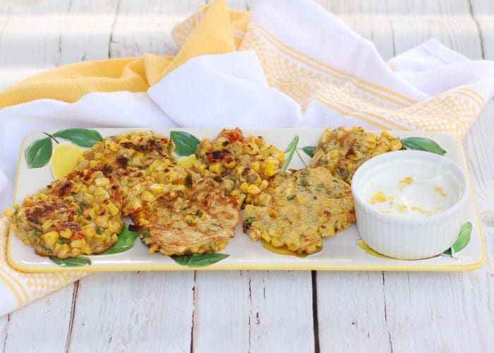 Corn & Basil Cakes on Tray with Sauce