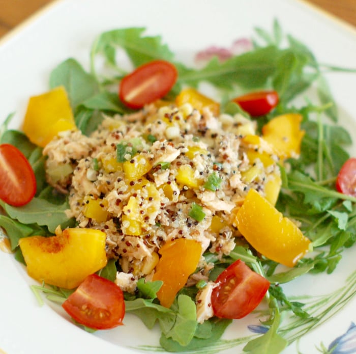 salmon peach salad on bed of lettuce