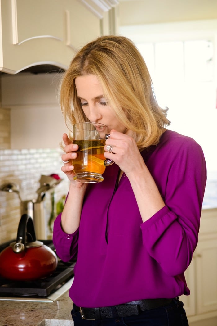 woman drinking cup of hot tea