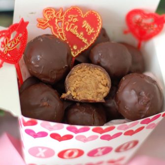 Rich & creamy chocolate peanut butter truffles are a decadent treat made healthier with Greek yogurt, maple syrup, natural peanut butter, & dark chocolate.