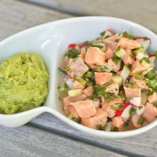 Salmon Ceviche with Cucumbers in serving bowl with guacamole