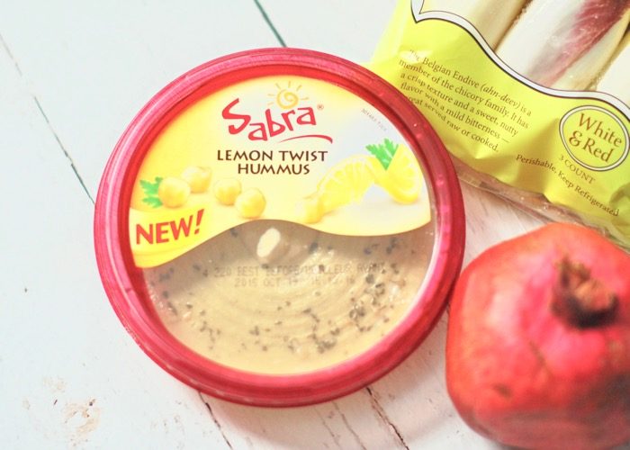 Sabra Lemon Twist Hummus is used to make lemon hummus endive boats, a quick and easy appetizer perfect for feeding a crowd.