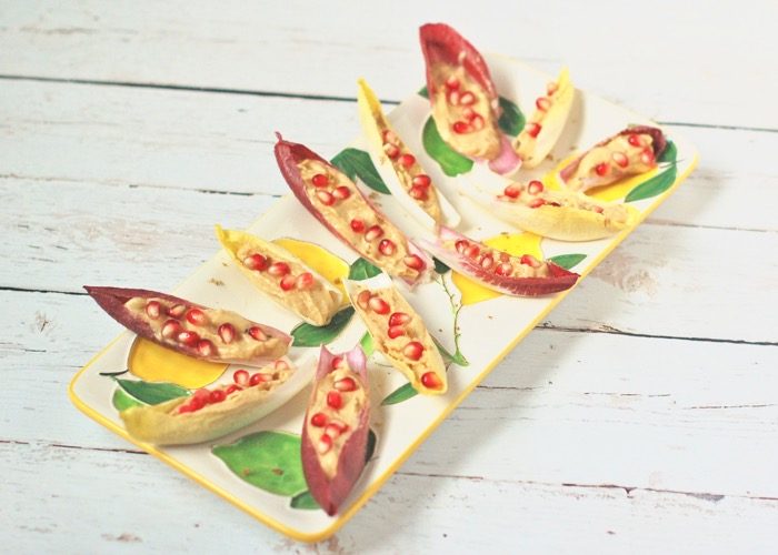 lemon hummus endive boats with pomegranate seeds hors d'oeuvres