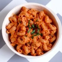 pasta with creamy roasted red pepper tomato sauce in a bowl