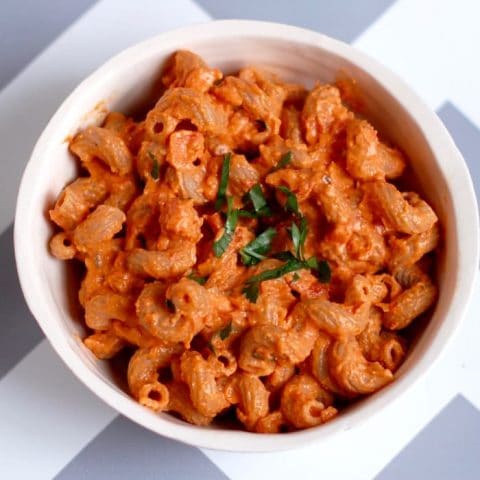 pasta with creamy roasted red pepper tomato sauce in a bowl