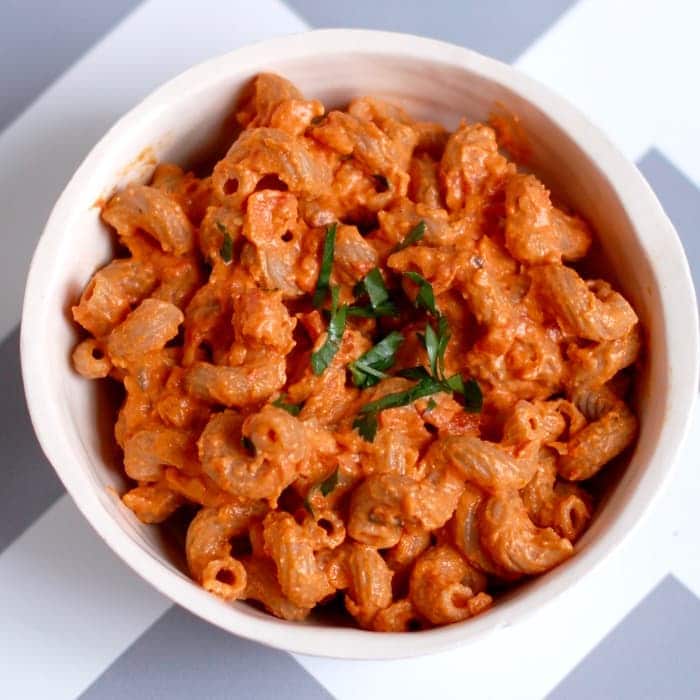 creamy roasted red pepper tomato pasta in serving bowl