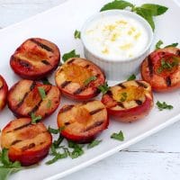 Grilled Stone Fruit with Yogurt Sauce is a naturally delicious, low-calorie, vegetarian and gluten-free end to your summer BBQ. Get the gluten-free, vegetarian recipe @jlevinsonrd.