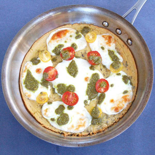 Overhead of Farinata with Tomato Mozzarella and Pesto