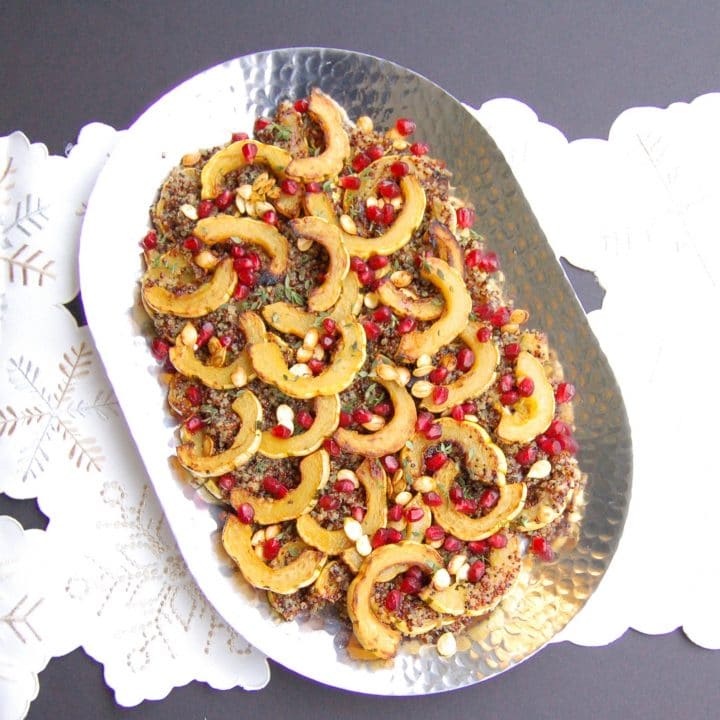 Maple-roasted delicata squash tops cider-infused quinoa and is garnished with thyme and pomegranate seeds in this easy, yet elegant side dish that's perfect for the holidays or any day of the week. Vegan, gluten-free, and nut-free recipe.