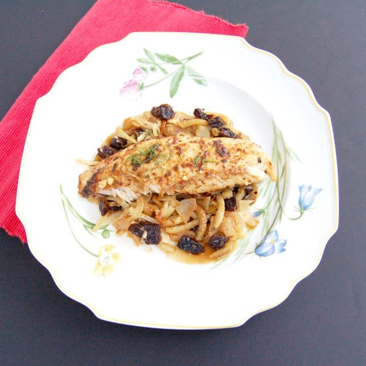 Baked Tilapia with Fennel & Dried Plums | Herb and spice-rubbed baked tilapia is served over a bed of caramelized fennel, onions, and dried plums for a quick and easy weeknight dinner and delicious way to boost your seafood intake. Get the gluten-free and dairy-free recipe @jlevinsonrd.