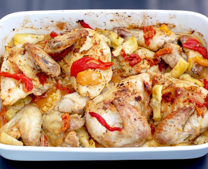 Roasted chicken with artichokes, peppers, and sun-dried tomatoes is a one-pan recipe