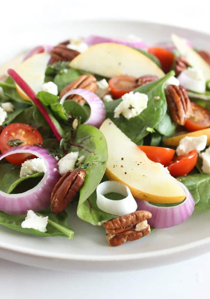 Close Up of Spinach Pear Salad with Goat Cheese