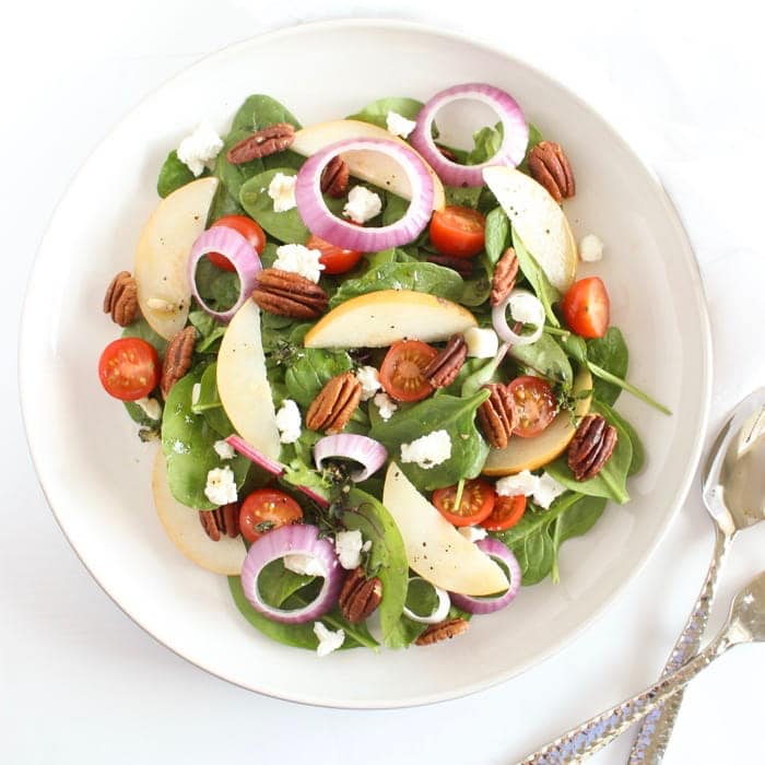 Spinach Pear Salad in White Bowl Overhead