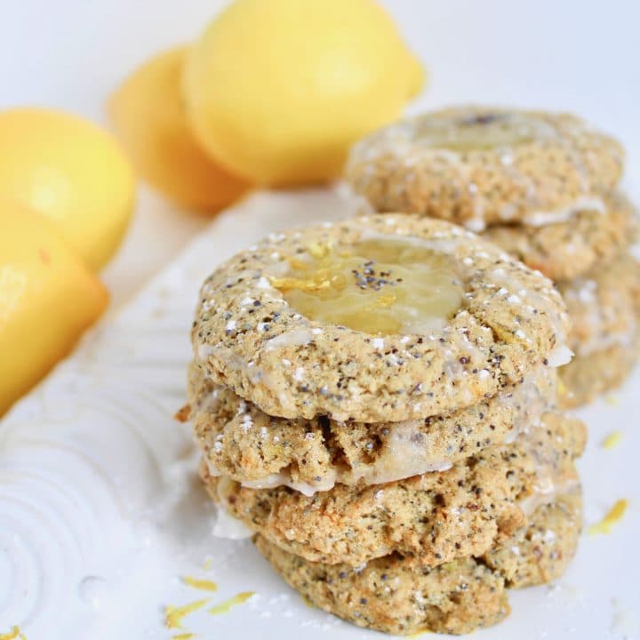 Welcome spring with this sweet and tangy Lemon Poppy Seed Thumbprint Cookie recipe! Soft and chewy lemon poppy seed cookies are dolloped with zesty lemon curd and a simple glaze for the perfect springtime treat. Get the vegetarian and nut-free recipe at JessicaLevinson.com