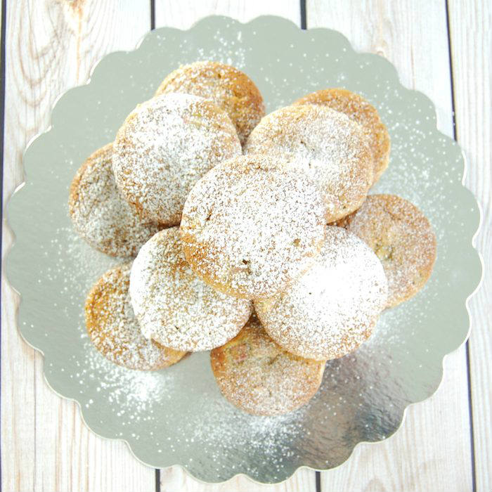 Rhubarb Ginger Lemon Muffins dusted with powdered sugar and Stacked on Dish