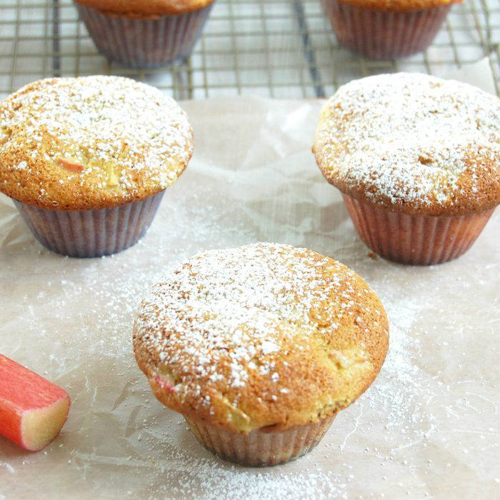 Rhubarb Ginger Lemon Muffins on parchment paper with Powdered Sugar