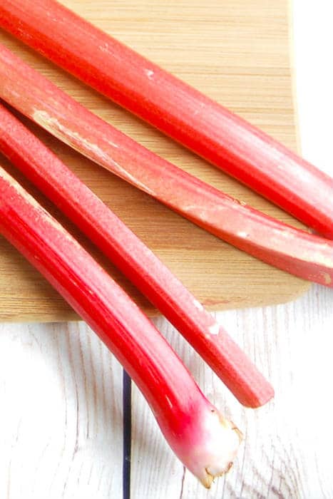 stalks of rhubarb on cutting board