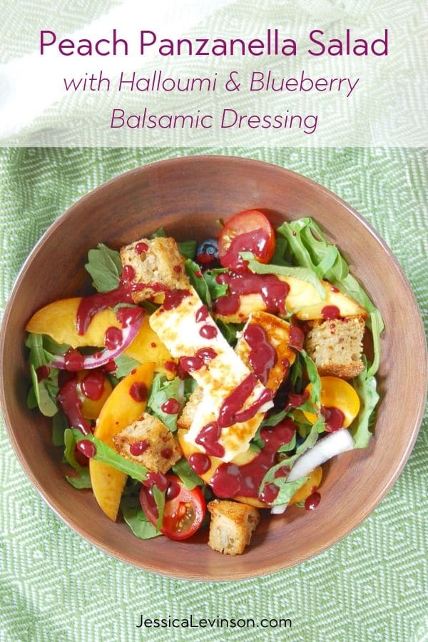 peach panzanella salad topped with blueberry balsamic dressing
