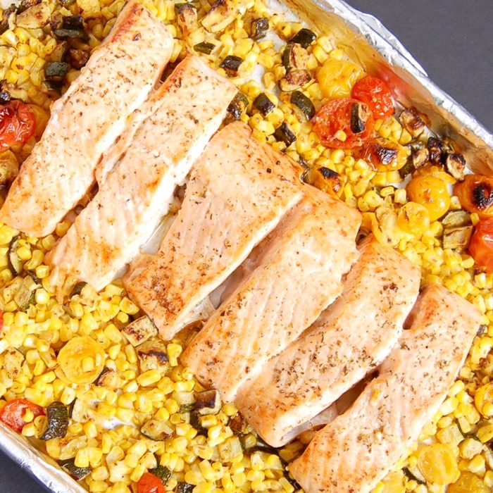 Mediterranean Sheet Pan Salmon with Zucchini, Corn, and Tomatoes is quick and easy to make and clean up. A perfect weeknight dinner for busy families. Get the recipe at JessicaLevinson.com | #glutenfree #dairyfree #eggfree #nutfree #salmon #recipe #sheetpanmeal #sheetpandinner #zucchini #corn #tomatoes #summerrecipes #summerveggies