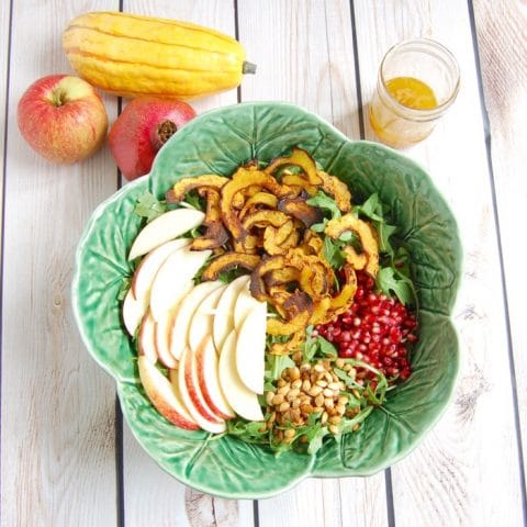 Enjoy the flavors of fall with this pretty and delicious Roasted Delicata Squash Apple Salad. A perfect side dish or starter salad, especially for the holidays. via JessicaLevinson.com | #pomegranates #delicatasquash #fallrecipes #salad #vegan #dairyfree #glutenfree #nutfree #apples