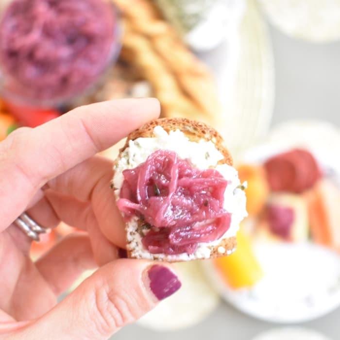 red onion jam on cracker with cheese close up