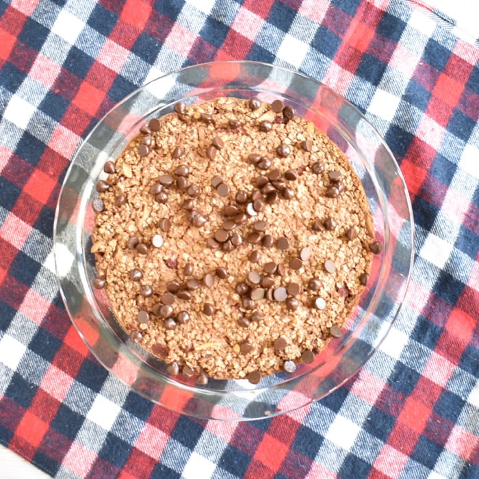 Chocolate baked oatmeal with berries and almond milk in baking dish