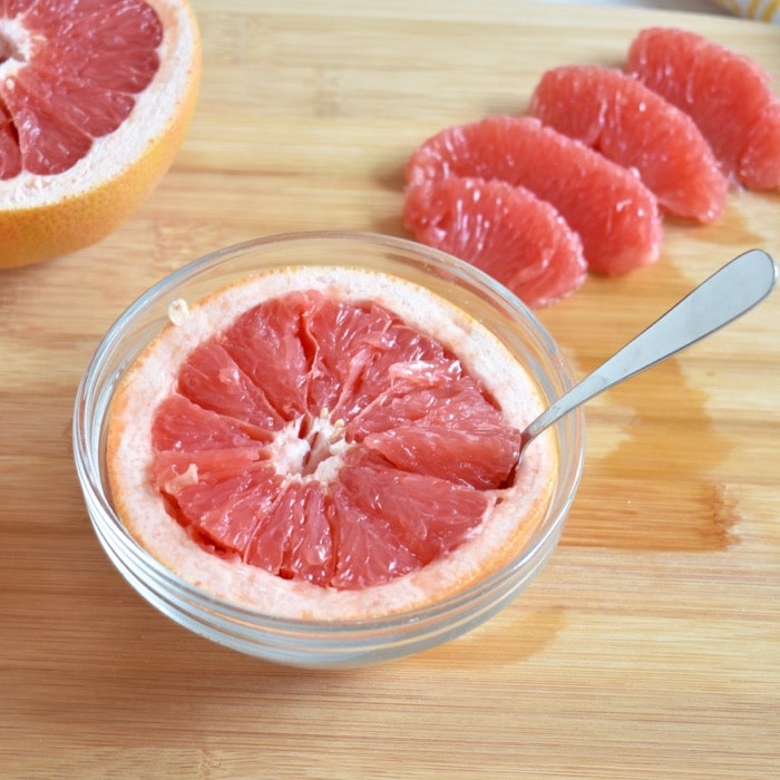 Enjoy grapefruit cut in half and eaten by spoon