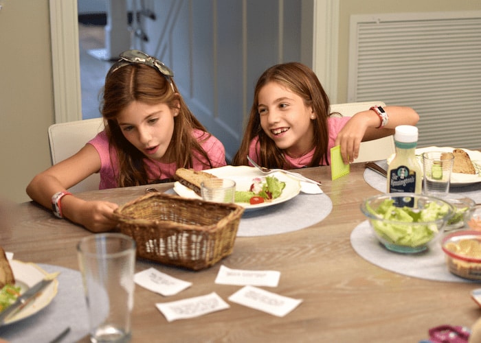 children sitting at family dinner