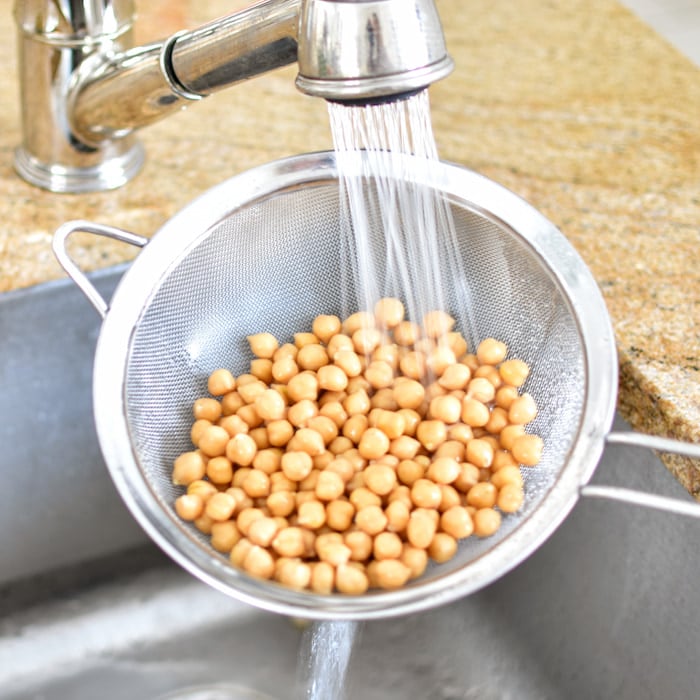 rinsing canned beans in a strainer